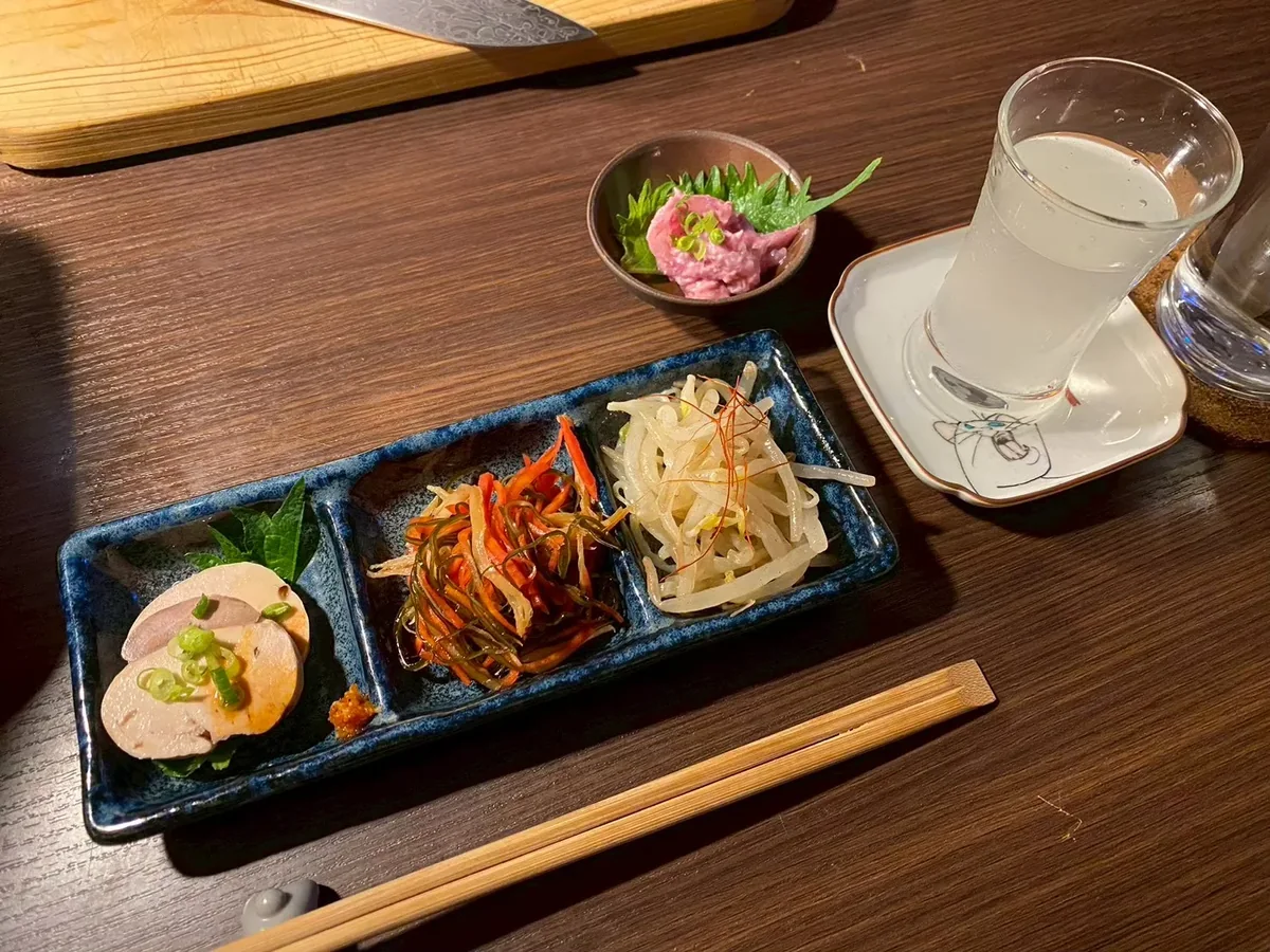 Several small dishes served together at the counter